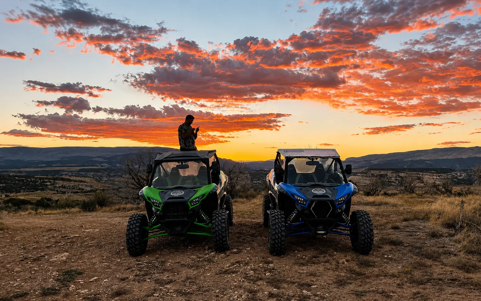 Two side-by-side UTVs at a ridgetop overlook at vivid sunset near Vernal, Utah